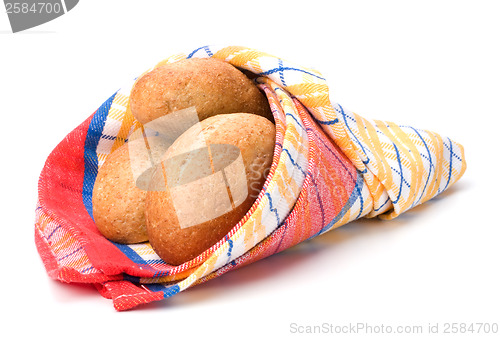 Image of fresh warm rolls over kitchen towel isolated on white background