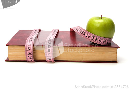 Image of tape measure wrapped around book isolated on white background