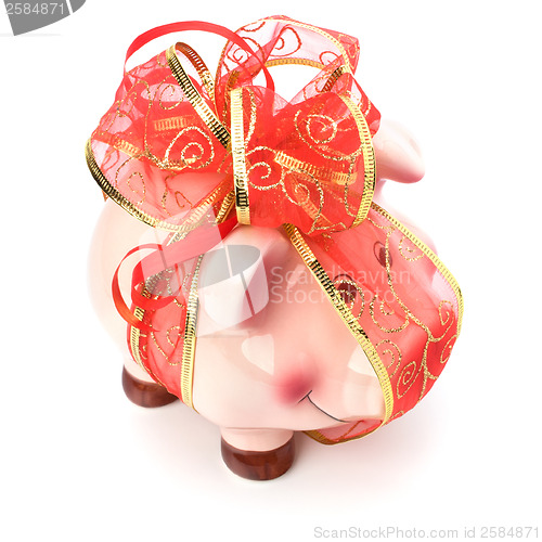 Image of Christmas deposit concept. Piggy bank with festive bow isolated 