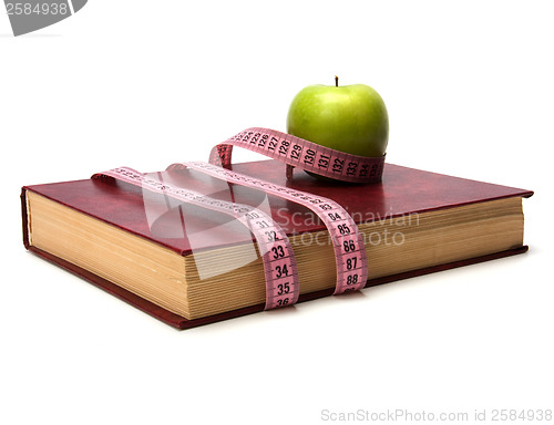 Image of tape measure wrapped around book isolated on white background