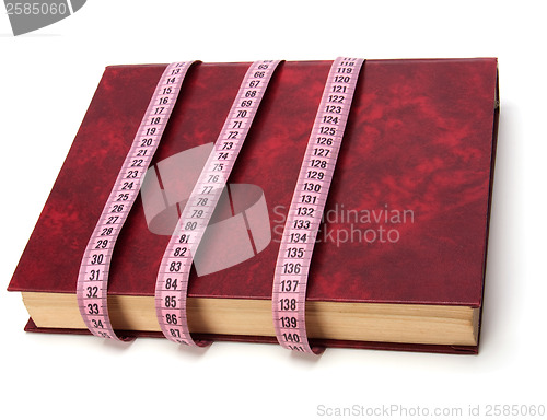 Image of tape measure wrapped around book isolated on white background