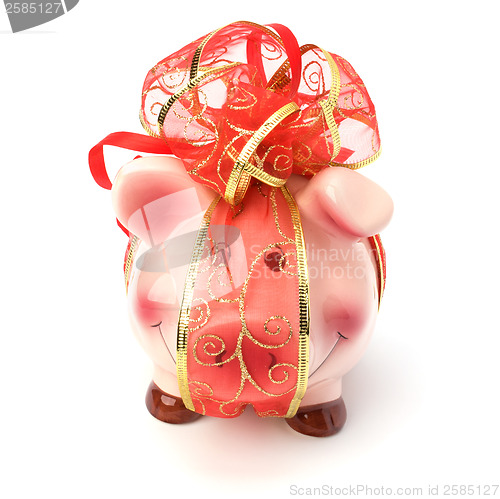 Image of Christmas deposit concept. Piggy bank with festive bow isolated 