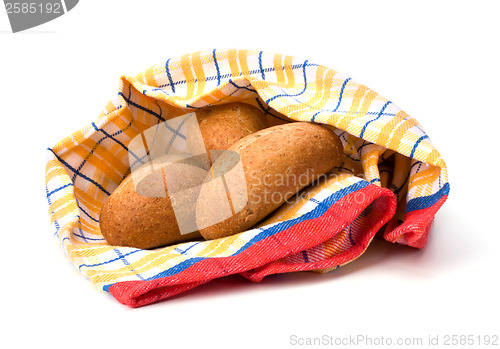 Image of fresh warm rolls over kitchen towel isolated on white background