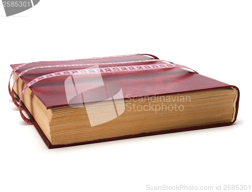 Image of tape measure wrapped around book isolated on white background