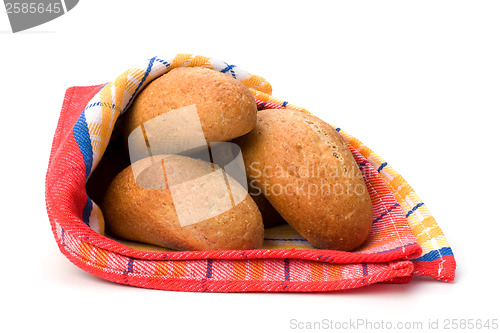 Image of fresh warm rolls over kitchen towel isolated on white background