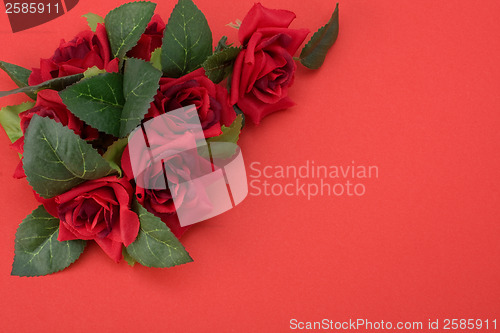 Image of Red background with floral decor. Flowers are artificial. 