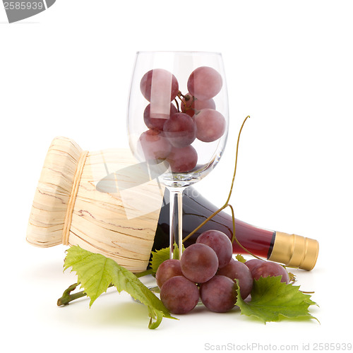 Image of red wine bottle and glass full with grapes  
