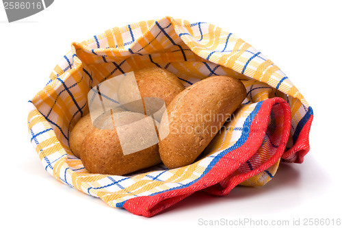 Image of fresh warm rolls over kitchen towel isolated on white background