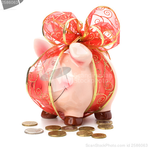 Image of Christmas deposit concept. Piggy bank with festive bow isolated 