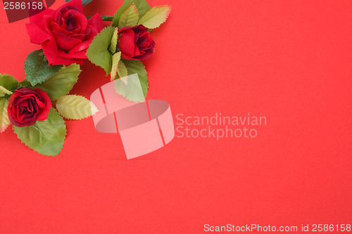 Image of Red background with floral decor. Flowers are artificial. 