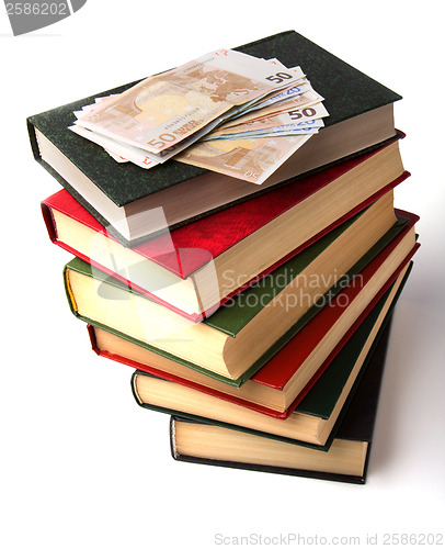 Image of Money over book stack.  Education  concept
