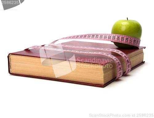 Image of tape measure wrapped around book isolated on white background