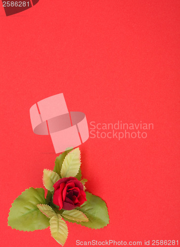 Image of Red background with floral decor. Flowers are artificial. 