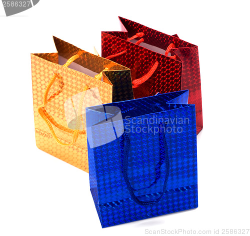 Image of shiny paper gift bags isolated on white background 