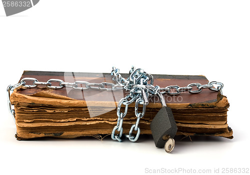 Image of tattered book with chain and padlock isolated on white backgroun