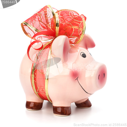 Image of Christmas deposit concept. Piggy bank with festive bow isolated 