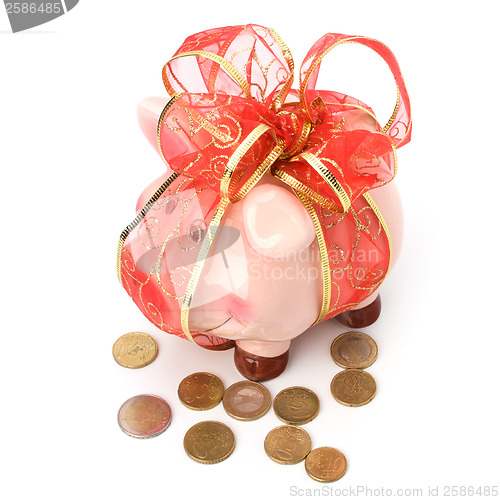 Image of Christmas deposit concept. Piggy bank with festive bow isolated 