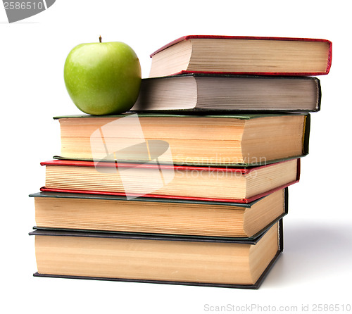 Image of book stack with apple isolated on white background 