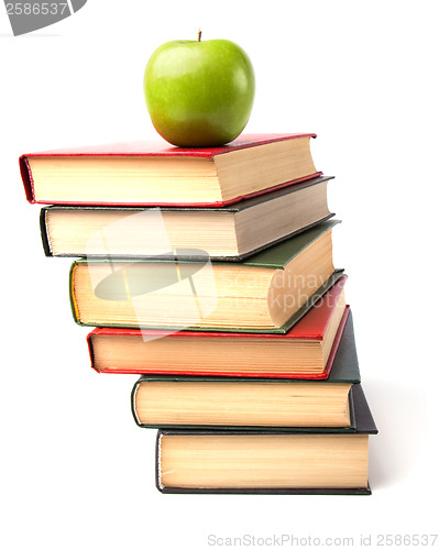 Image of book stack with apple isolated on white background 