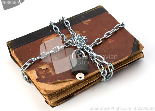 Image of tattered book with chain and padlock isolated on white backgroun