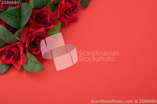 Image of Red background with floral decor. Flowers are artificial. 