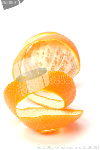 Image of orange with peeled spiral skin isolated on white background