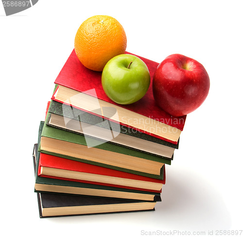 Image of book stack with fruits isolated on white background 