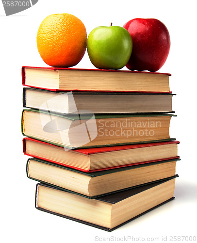 Image of book stack with fruits isolated on white background 