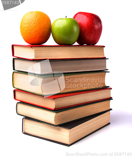 Image of book stack with fruits isolated on white background 
