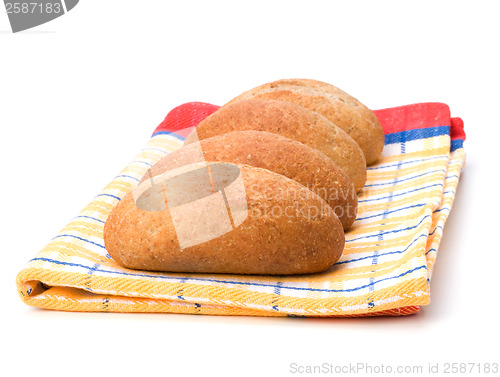 Image of fresh warm rolls over kitchen towel isolated on white background