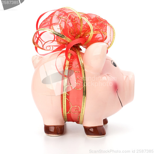 Image of Christmas deposit concept. Piggy bank with festive bow isolated 