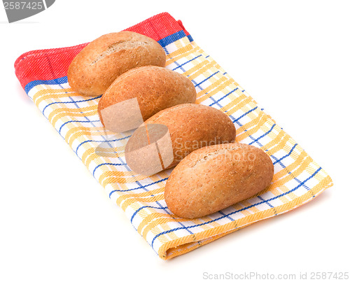 Image of fresh warm rolls over kitchen towel isolated on white background