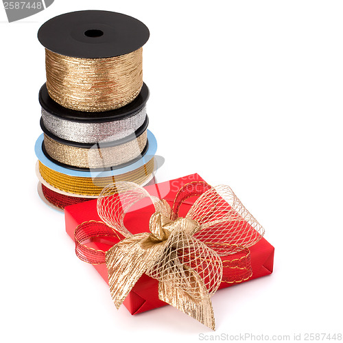 Image of Festive gift box and wrapping ribbons isolated on white backgrou