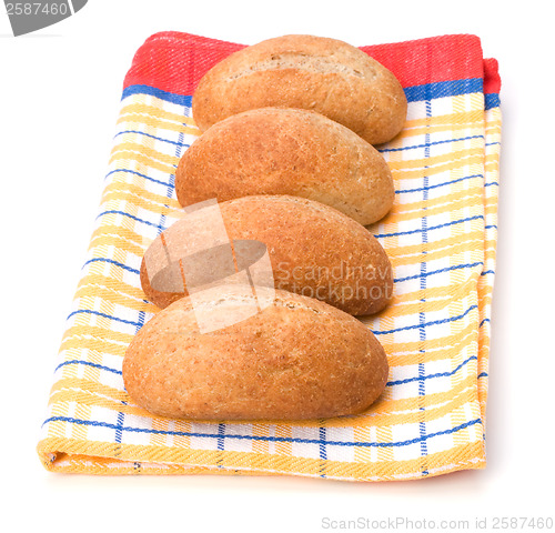 Image of fresh warm rolls over kitchen towel isolated on white background