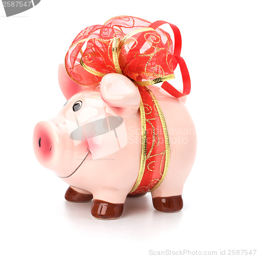 Image of Christmas deposit concept. Piggy bank with festive bow isolated 