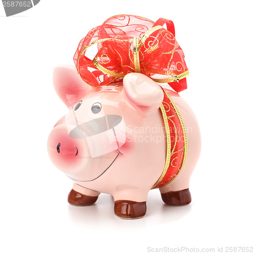 Image of Christmas deposit concept. Piggy bank with festive bow isolated 