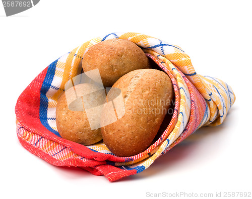 Image of fresh warm rolls over kitchen towel isolated on white background