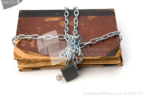 Image of tattered book with chain and padlock isolated on white backgroun