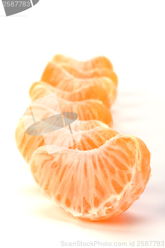 Image of peeled mandarin segments isolated on white background