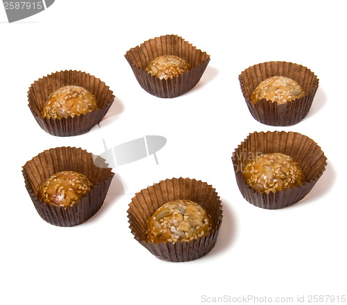 Image of Caramel sweets with sunflower seeds isolated on white 