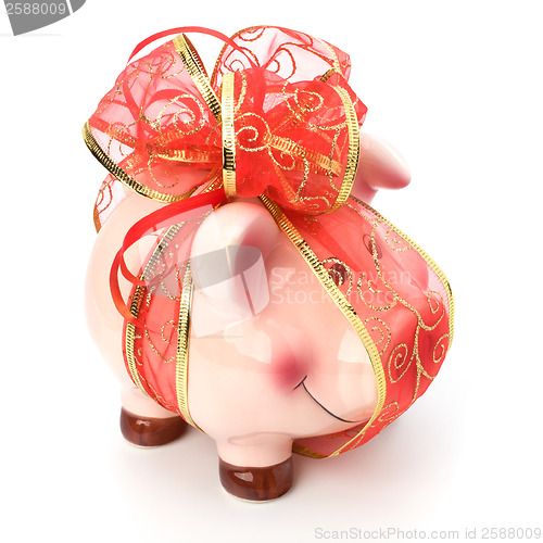 Image of Christmas deposit concept. Piggy bank with festive bow isolated 