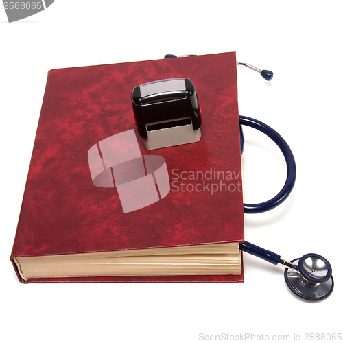 Image of stethoscope on red book isolated on white background