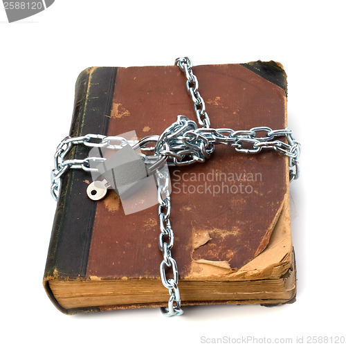 Image of tattered book with chain and padlock isolated on white backgroun
