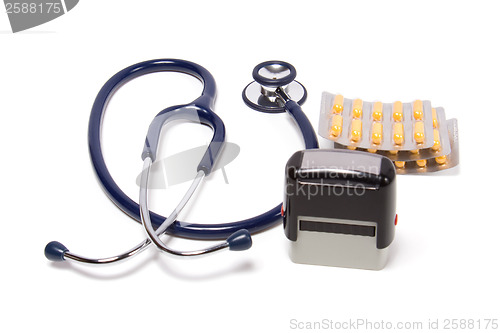 Image of stethoscope, tablets  and doctor seal isolated on white backgrou