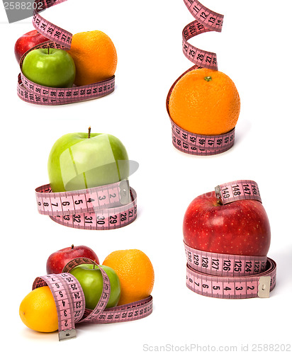 Image of  tape measure wrapped around fruits isolated on white background