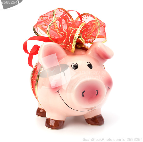 Image of Christmas deposit concept. Piggy bank with festive bow isolated 