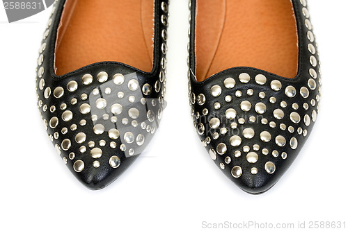 Image of Black women's leather ballet flats with steel rivets close up 