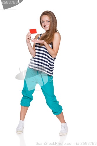 Image of Positive teen girl smiling showing credit card