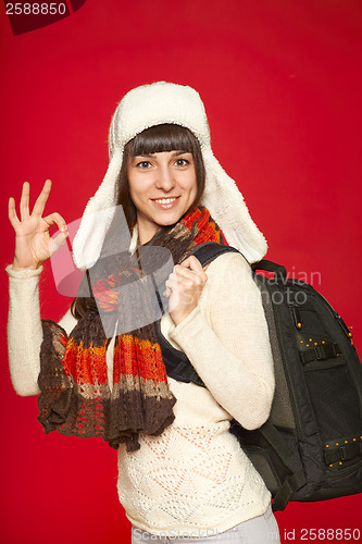 Image of Winter woman tourist with backpack
