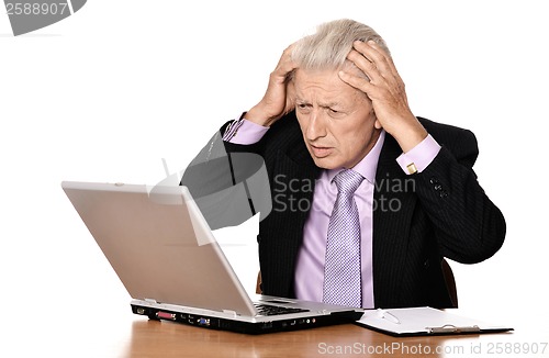 Image of Mature man sitting at the computer